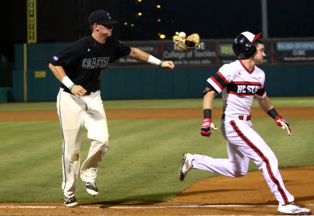 Kevin Woodall Jr. (19) loses his glove trying to tag Brock Deatherage (13). NC State hosted Coastal Carolina on the second day of the Raleigh Regional on June 4, 2016. (Photo by: Jerome Carpenter/WRAL contributor)