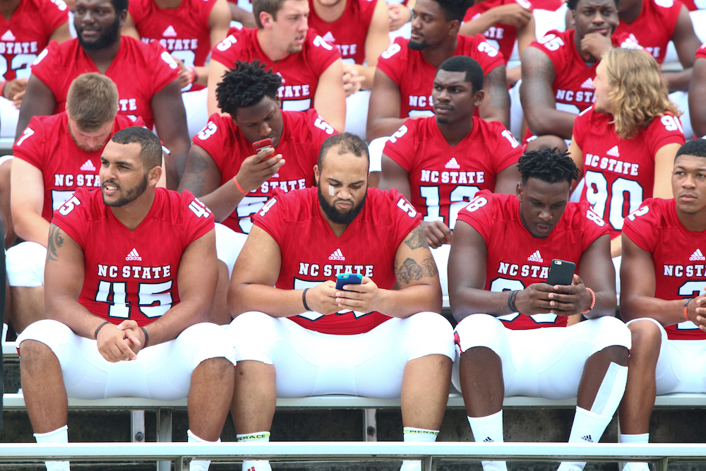 Pack players wait to take their team photo. NC State Football hosted Meet the Pack at Carter-Finley Stadium in Raleigh, North Carolina on August 7, 2016. (Jerome Carpenter/WRAL Contributor)