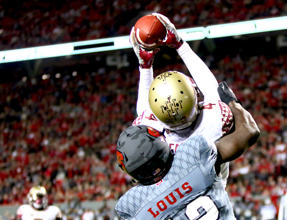 Tarvarus McFadden (4) goes up to grab an interception. Florida State defeated NC State 24-20 on November 5, 2016 at Carter-Finley Stadium in Raleigh, North Carolina. (Jerome Carpenter/WRAL Contributor)